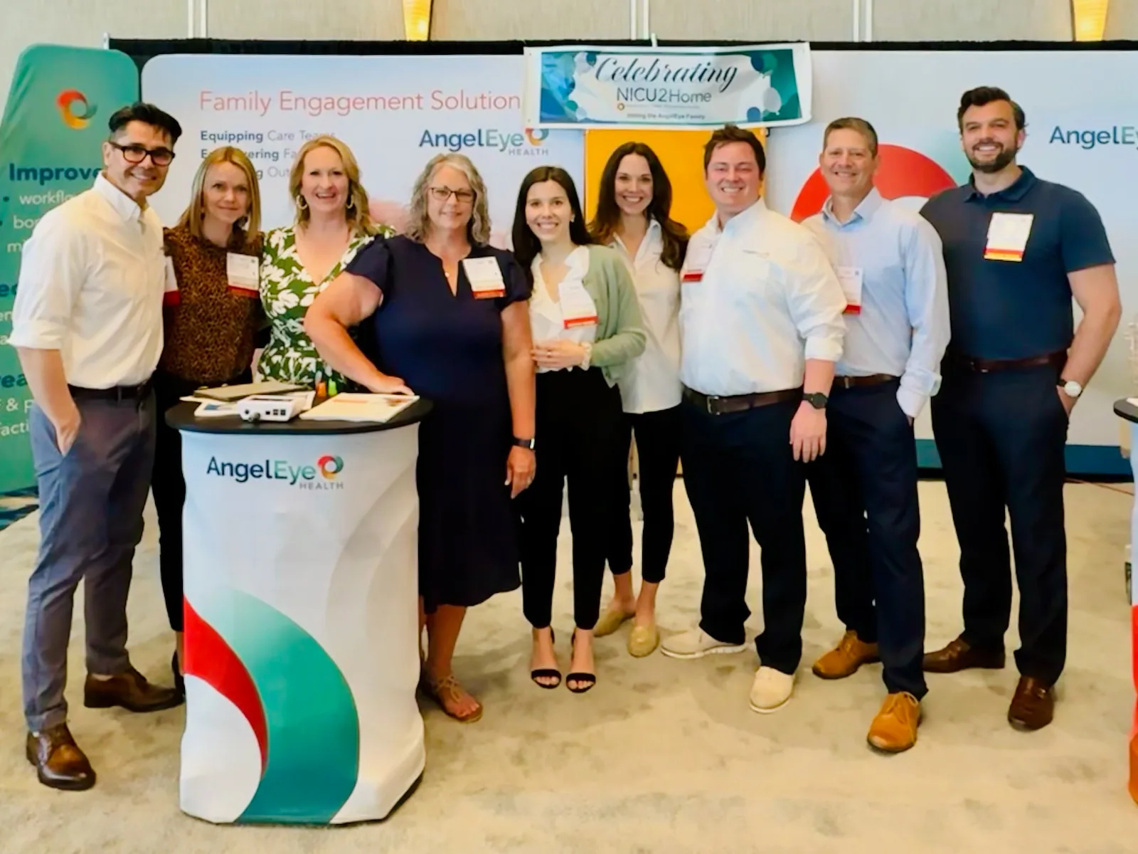 The Enlighten Mobility team and partners gathered at the AngelEye Health booth during a healthcare conference.
